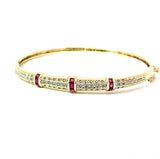 Aufregender Armreif in 14 Karat Gelbgold mit Rubinen und Diamanten