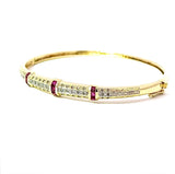 Aufregender Armreif in 14 Karat Gelbgold mit Rubinen und Diamanten