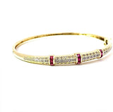 Aufregender Armreif in 14 Karat Gelbgold mit Rubinen und Diamanten
