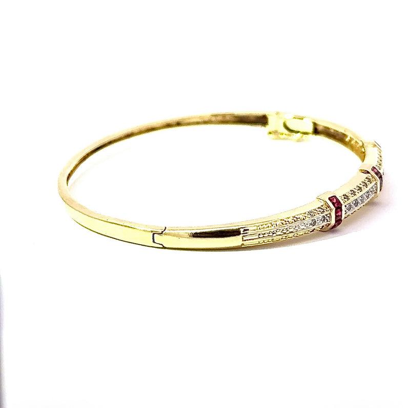 Aufregender Armreif in 14 Karat Gelbgold mit Rubinen und Diamanten