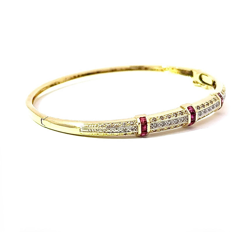 Aufregender Armreif in 14 Karat Gelbgold mit Rubinen und Diamanten