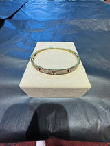 Aufregender Armreif in 14 Karat Gelbgold mit Rubinen und Diamanten
