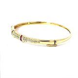 Aufregender Armreif in 14 Karat Gelbgold mit Rubinen und Diamanten