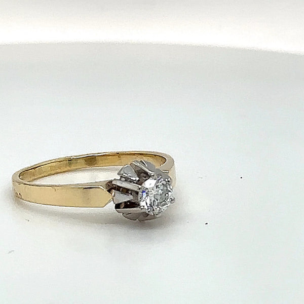 Handmade solitaire ring in 14 carat yellow and white gold with fine diamonds