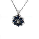 Beautiful vintage flower in 14 carat with fine sapphires and brilliant-cut diamonds, with chain