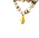 Natural colored pearl necklace with 18k yellow gold pendant with brilliants